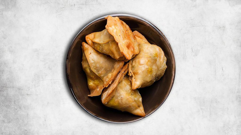 Samosa Special (2 Pcs) · A crisp and spicy deep-fried snack with a crisp and flaky outer layer and a rich filling of mashed potato, peas, and spices served with mint and tamarind chutney
