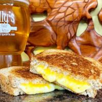 Grilled Cheese · Vegetarian. Cheddar, Swiss, Provolone Cheese melted to perfection on sliced Whole Wheat Bread.