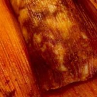 Red Salsa Tamal · dough mixture that is filled with red salsa and pork wrapped and cooked in corn husks leaves,