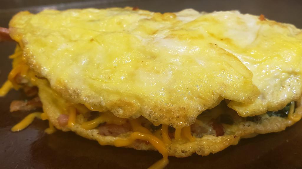 Meat Lover Omelette · Three eggs, sausage, bacon, ham, cheese.
