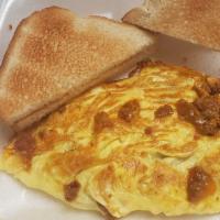 Chili & Cheese Omelette · Three eggs omelette with seasoned chili, beans, cheese, jalapeño omelette with toast and jel...
