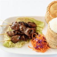 Moo-Ping And Sticky Rice · Grilled pork skewers served with sticky rice and homemade sauce.