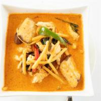 Red Curry · Hot. Red curry paste cooked in creamy coconut milk with bamboo shoots, bell peppers, and fre...
