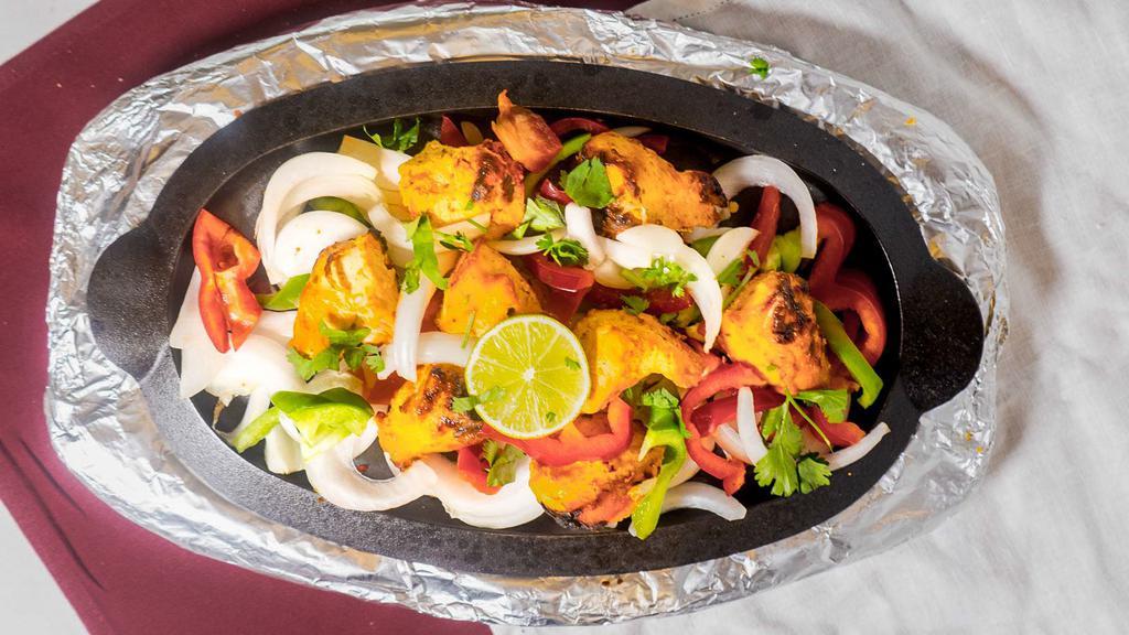 Chicken Tikka · Delicious boneless chicken breast marinated in spices and yogurt and cooked in a tandoor.