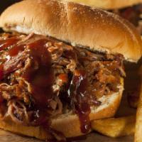 Pulled Pork Sandwich · Pork shoulders and butts smoked over hardwood and lump charcoal for 15 hours then hand pulle...