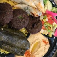 Veggie Plate · A tasty combination of falafel, stuffed grape leaves and spanakopita (no rice). Served with ...