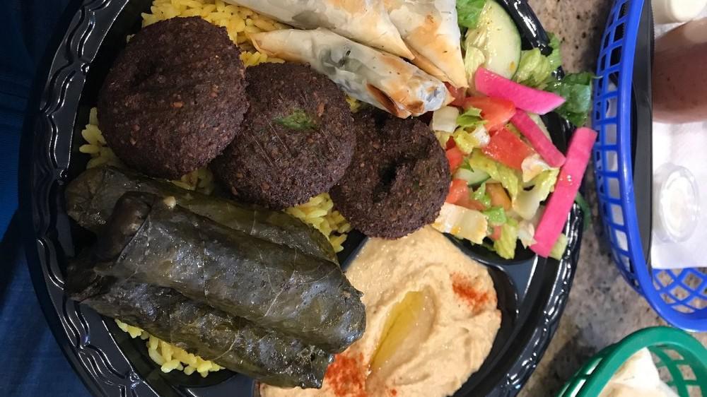 Veggie Plate · A tasty combination of falafel, stuffed grape leaves and spanakopita (no rice). Served with salad, hummus, and pita bread.
