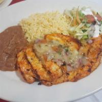 Pechuga De Pollo Asado · Broiled chicken breast with onions. Served with rice, refried beans, and salad.