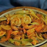 Fajita Mixtas · Chicken, beef, and shrimp. Sautéed with sliced onion, tomato and green pepper accompanied wi...