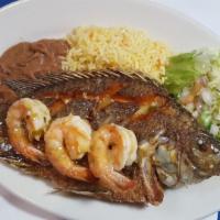 Pescado Frito · Tilapia pan-fried a whole fish accompanied with rice, refried beans, and salad.