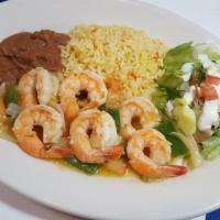 Camarones Al Vino · Large shrimp sauteed in butter wine sauce with garlic and cilantro accompanied with rice, re...
