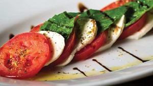 Insalata Caprese · Perfectly ripened roma tomatoes, fresh mozzarella, and garden-fresh basil, drizzled with bal...
