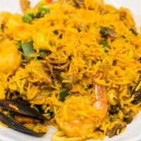 Paella · Shrimp, mussels, scallops, calamari, sausage and chorizo, chicken, tomatoes, mushrooms, squa...