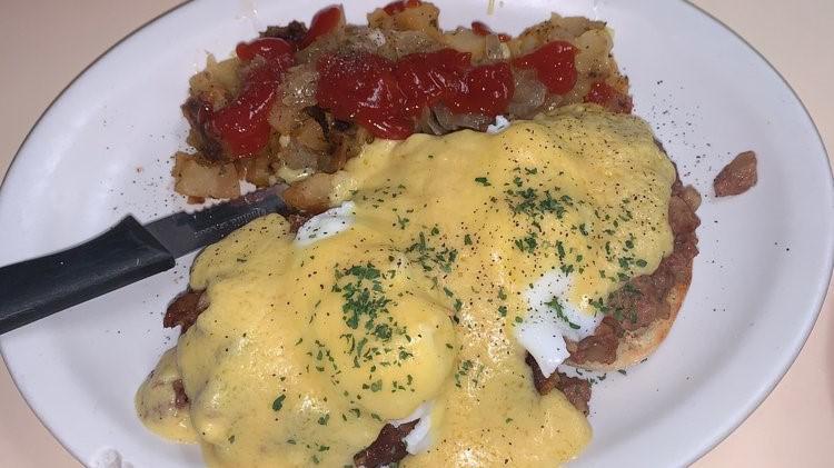 Hash Benedict · English muffin topped with corned beef hash, two poached eggs, and Hollandaise sauce. 
Served with home fries.