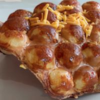 Bubble Waffle - Cheese Lover · Original bubble waffle filled with sharp cheddar cheese.