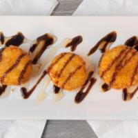 Fried Goat Cheese · Lightly breaded and drizzled with honey and balsamic reduction.