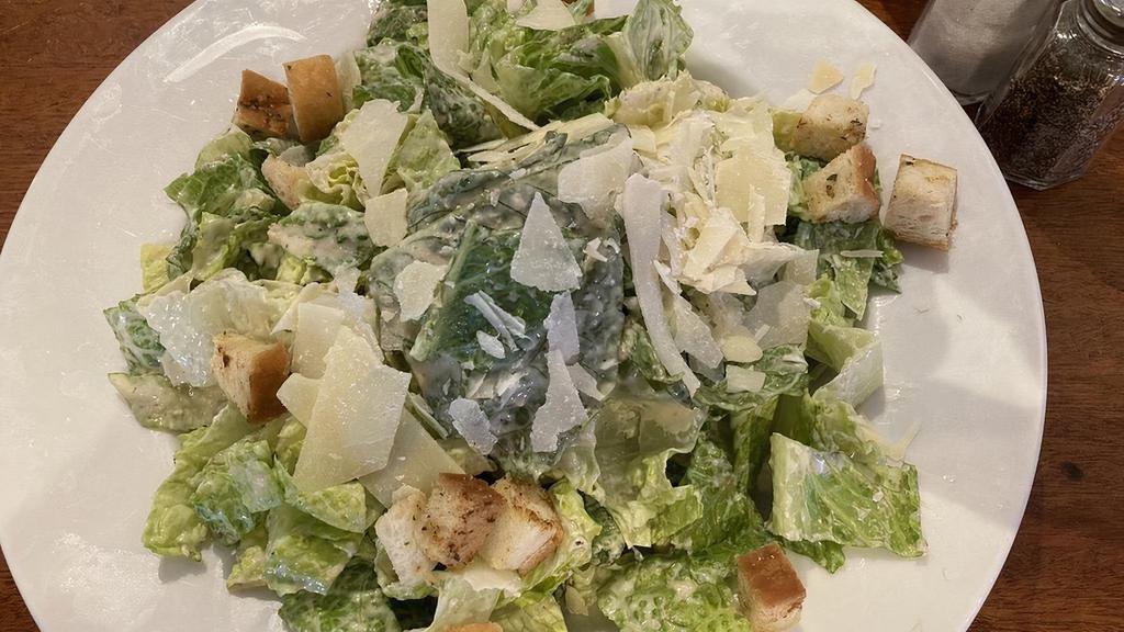 Caesar Salad · Romaine lettuce, Parmesan cheese and croutons with Caesar dressing.