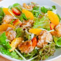 Asian Salad · Baby cucumbers, sweet mandarin oranges, crispy noodles, sliced almonds and scallions on a be...