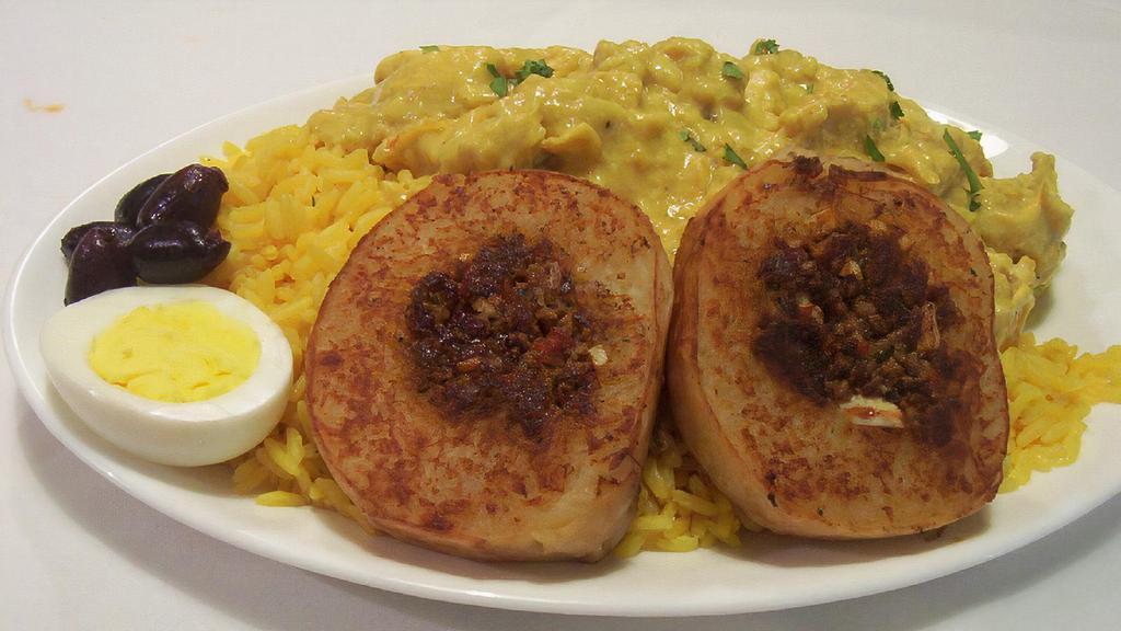 Aji De Gallina · Yellow curry chicken served over Spanish rice and grilled stuffed potatoes, olives and eggs.