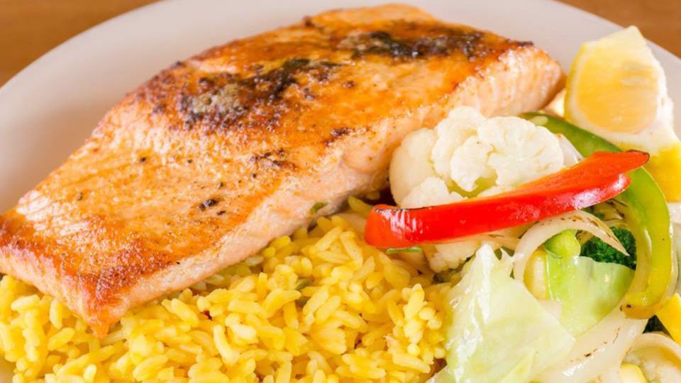 Grilled Salmon · Served with sautéed vegetables and seasoned rice.