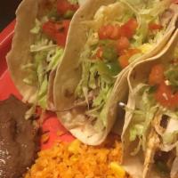 Tacos · Cheese, shredded lettuce, pico de gallo served with rice & refried beans.