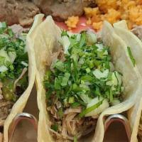 Street Tacos · Soft corn torillas, slow roasted pork, cilantro, onion, queso fresco & salsa verde.