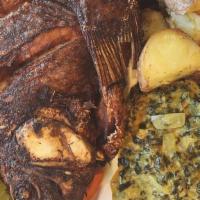 Fried Fish · Whole fried tilapia paired with the choice of two delicious sides.