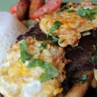 Bistec A Lo Pobre · Grilled marinated steak served with two sunny sides up eggs. French fries, rice, and plantain.