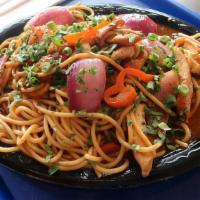 Tallarin Saltado · Peruvian dish made with spaghetti sautéed with tender chicken, red onions, tomatoes, peppers...