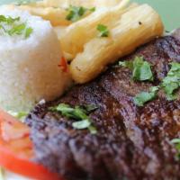 Carne Asada · Grilled seasoned steak served with two sides.