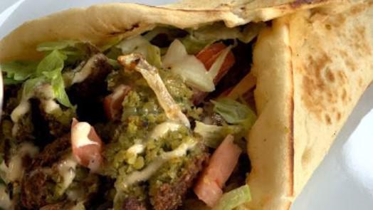 Falafel Pita · Served with lettuce, tomato, grilled onion, and zone white sauce on pita bread.