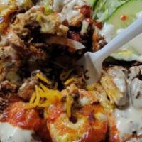 Triple Zone Platter (Lamb, Shrimp & Chicken) With Grilled Onion & Pepper · Basmati rice, garnished with lettuce and tomato & zone white  sauce.