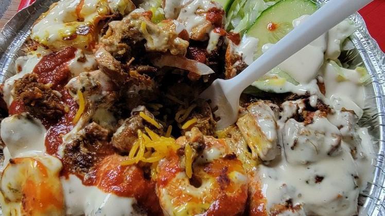 Triple Zone Platter (Lamb, Shrimp & Chicken) With Grilled Onion & Pepper · Basmati rice, garnished with lettuce and tomato & zone white  sauce.