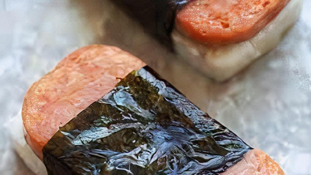 Spam Musubi · Pan seared Spam  placed on top of Packed rice and wrapped in nori (dried seaweed.)