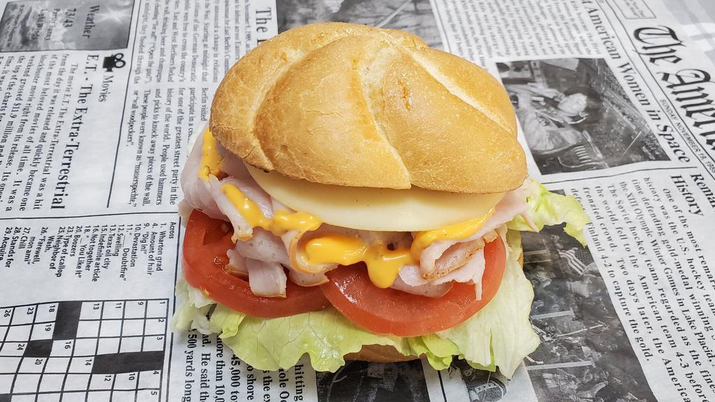 Georgetown · Freshly sliced turkey breast, provolone cheese, lettuce, tomato and russian dressing on a kaiser roll or on your choice of bread.
