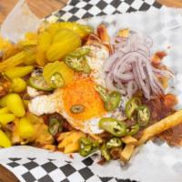Tiger Fry · House chili, BBQ sauce, cheese sauce, sunny side up egg, pickled serranos, dill pickles, and...