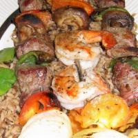 Shish Kabob · Skewered with seasonal vegetables and served on a bed of rice.