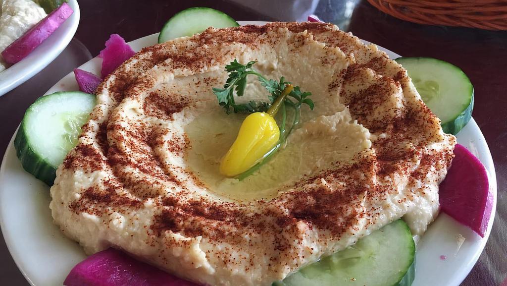 Hummus Ma-Lahm · The hummus dip topped with your choice of lamb, beef, chicken, gyro or our ground sirloin and onion mixture.