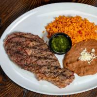 Carne Asada · Grilled  Steak marinated in fresh herbs, peppers, chilies, lime juice and olive oil. Grilled...