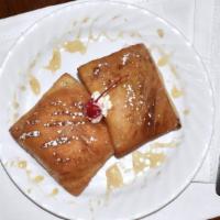 Sopapilla · Puffed pastry deep fried to a totally yummy crip golden brown, served with honey and cinnamon.
