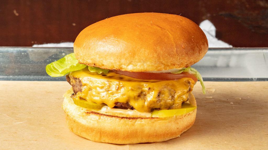 Angus Burger · 1/3 lb grass American fed Angus beef with onions, lettuce, tomato, pickles & American cheese on a brioche bun.