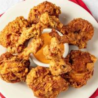 Lollipop Chicken · Pulled back chicken wings battered and fried to golden perfection