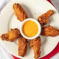 Chicken Wings (6Pc) · Buttermilk marinated fresh chicken wings fried and tossed with a sauce of your choice