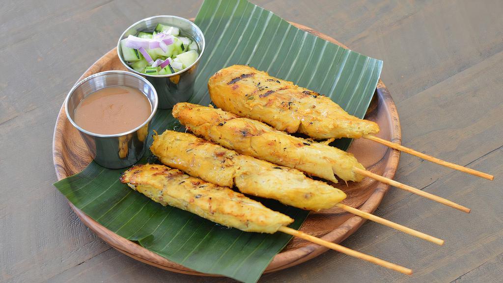 Satay · Grilled marinated chicken, served with peanut sauce and cucumber sauce. (4 skewers).