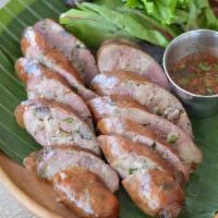 Lao Pork Sausage · Ground pork, lemongrass, galangal and herbs. Served with Lao traditional lime chili sauce
