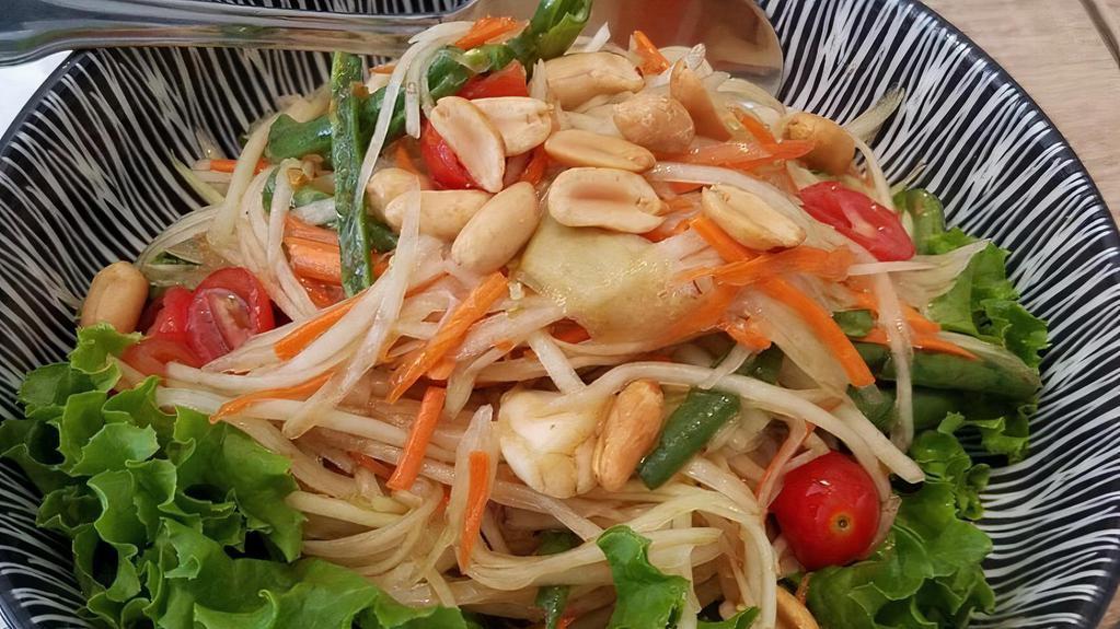 Papaya Salad · Gluten free. Hand shredded papaya, fresh chili, green bean, cherry tomatoes, palm sugar and tossed with lime juice. Sprinkle peanut on top.