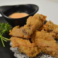 Chicken Wings · fried chicken wing lightly topped with japanese chili peppers and spicy mayo on side