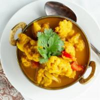 Alu Gobi · Cauliflower and potatoes cooked with onions, green peppers, tomatoes, spices and herbs.