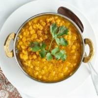 Daal Tarka · Yellow lentils slowly simmered in a traditional indian gravy of tomatoes and ginger.