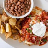 Enchiladas & Eggs · Two king ranch chicken enchiladas topped with two eggs, with ranchera salsa and sour cream o...